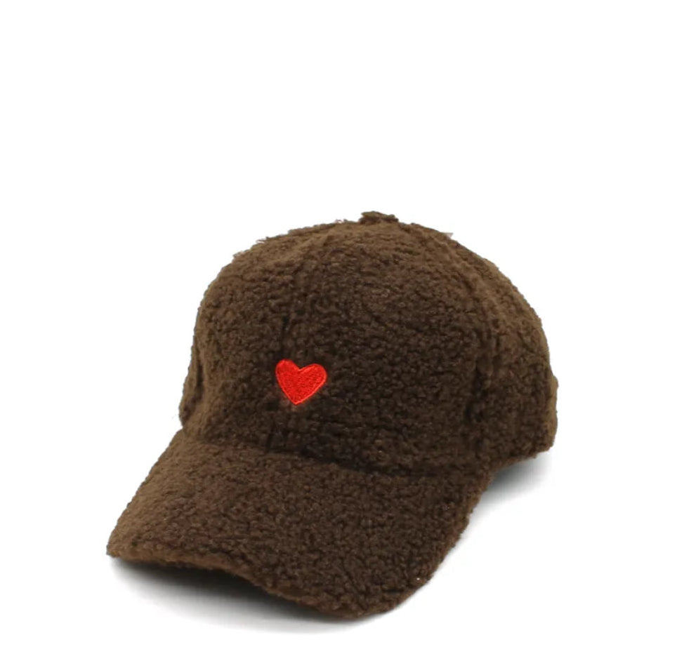 Brown fuzzy cap with a red heart