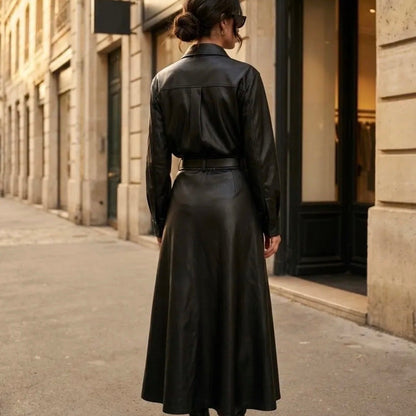 Model wearing KIDDING black high-waisted flared leather midi skirt with belt loops, paired with a matching black leather shirt and pointed heel boots on a Paris street