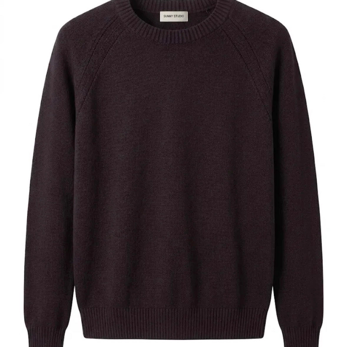 KIDDING brown knit raglan sweater with a ribbed crew neck and pointelle detail along the shoulders, displayed flat against a plain white background