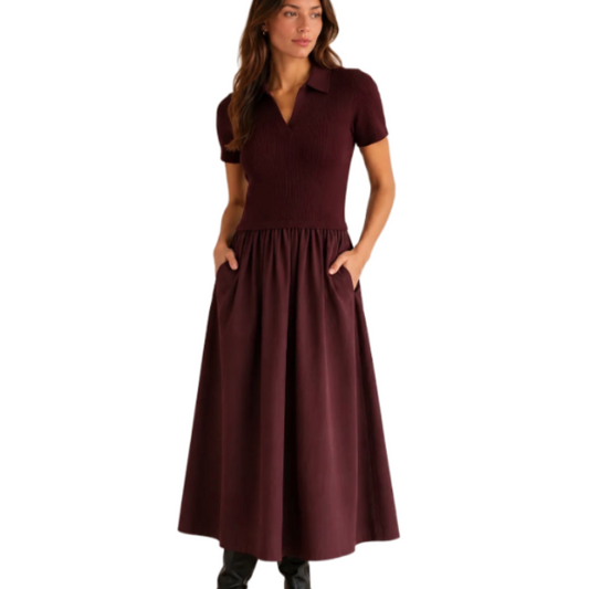 Model wearing KIDDING burgundy short-sleeve ribbed polo midi dress with gathered skirt and side pockets, paired with black leather boots